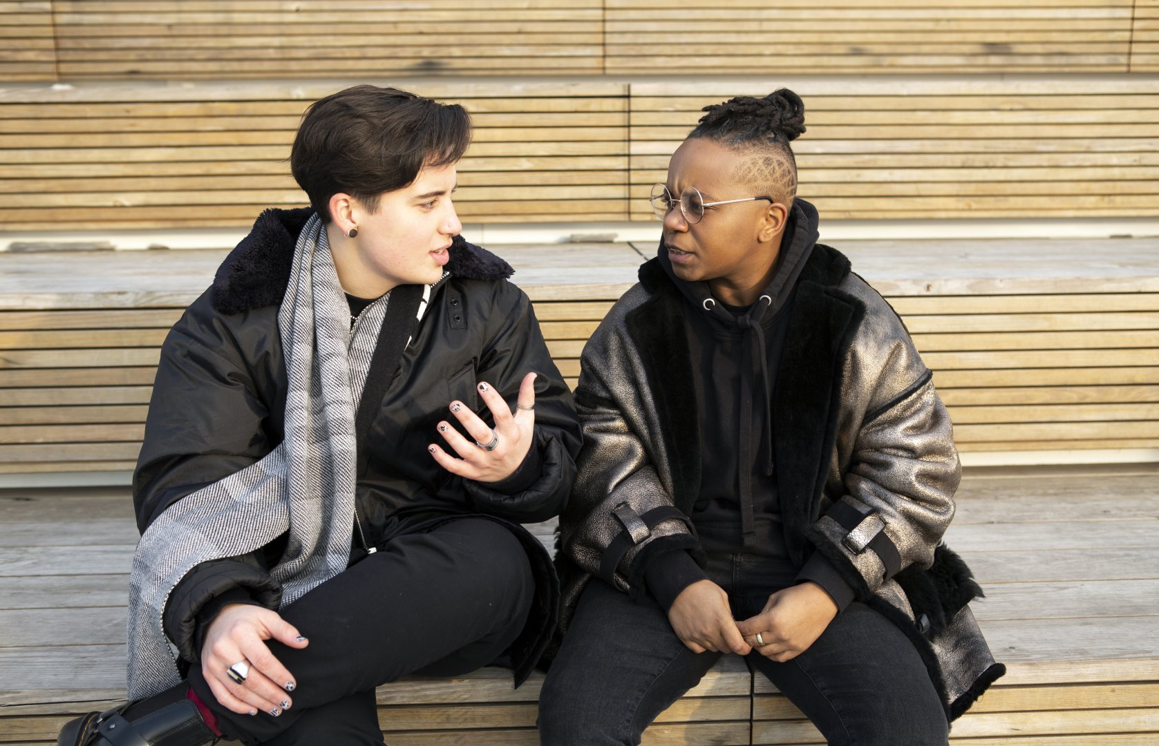 Two transmasculine people sitting together and having a serious conversation.  Photo by Zackary Drucker; The Gender Spectrum Collection