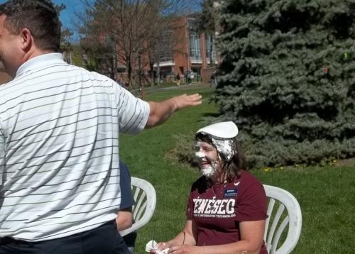 student with pie on her head