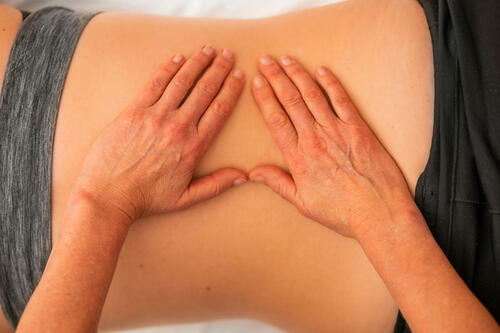 doctor's hands on a back