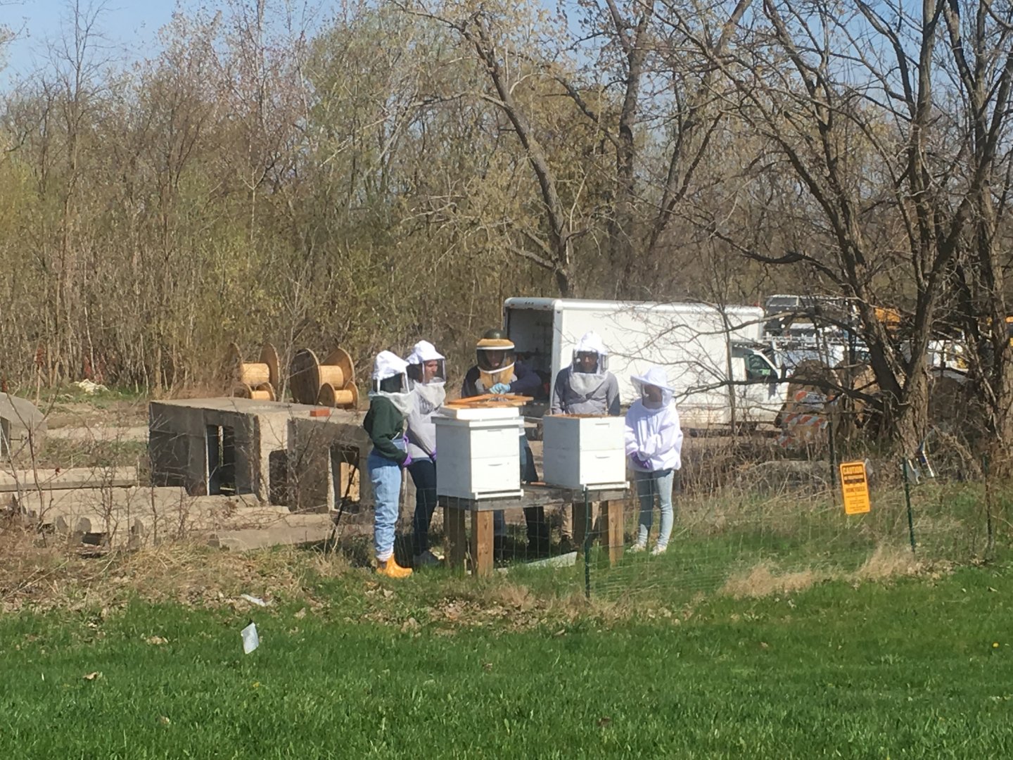 Five club members gathered around our two hives