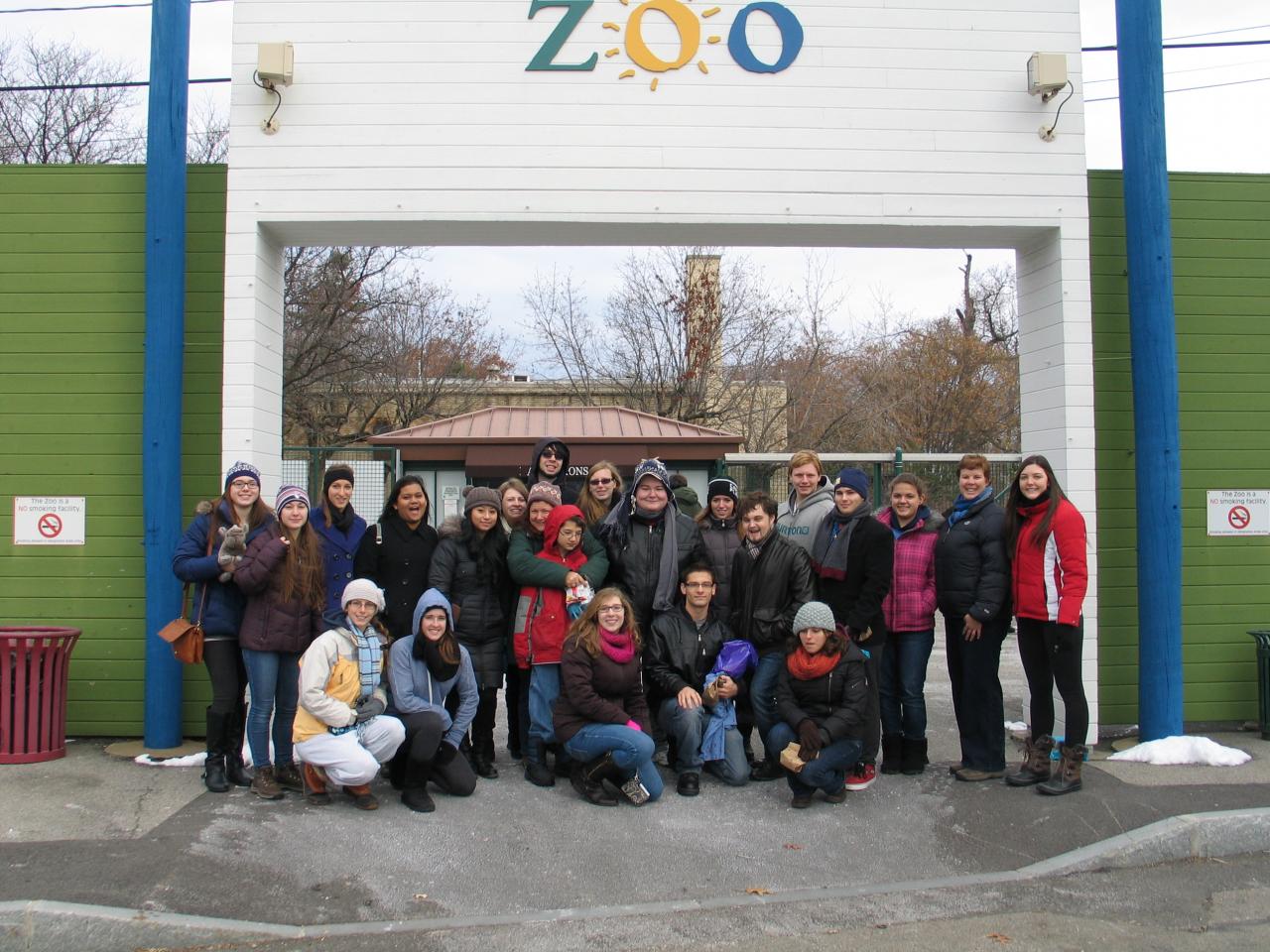 all students posing outside zoo entrance