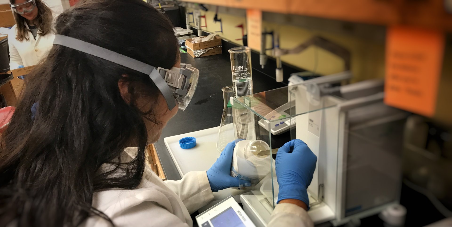 Students engaging chemical safety in the stockroom