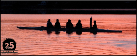 Geneseo crew club rowing on the water at sunrise