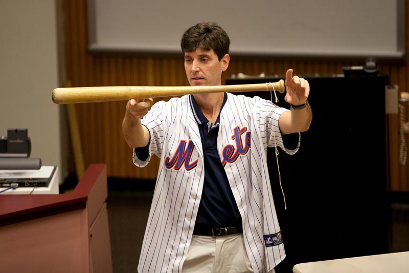 physics professor balancing a baseball bat