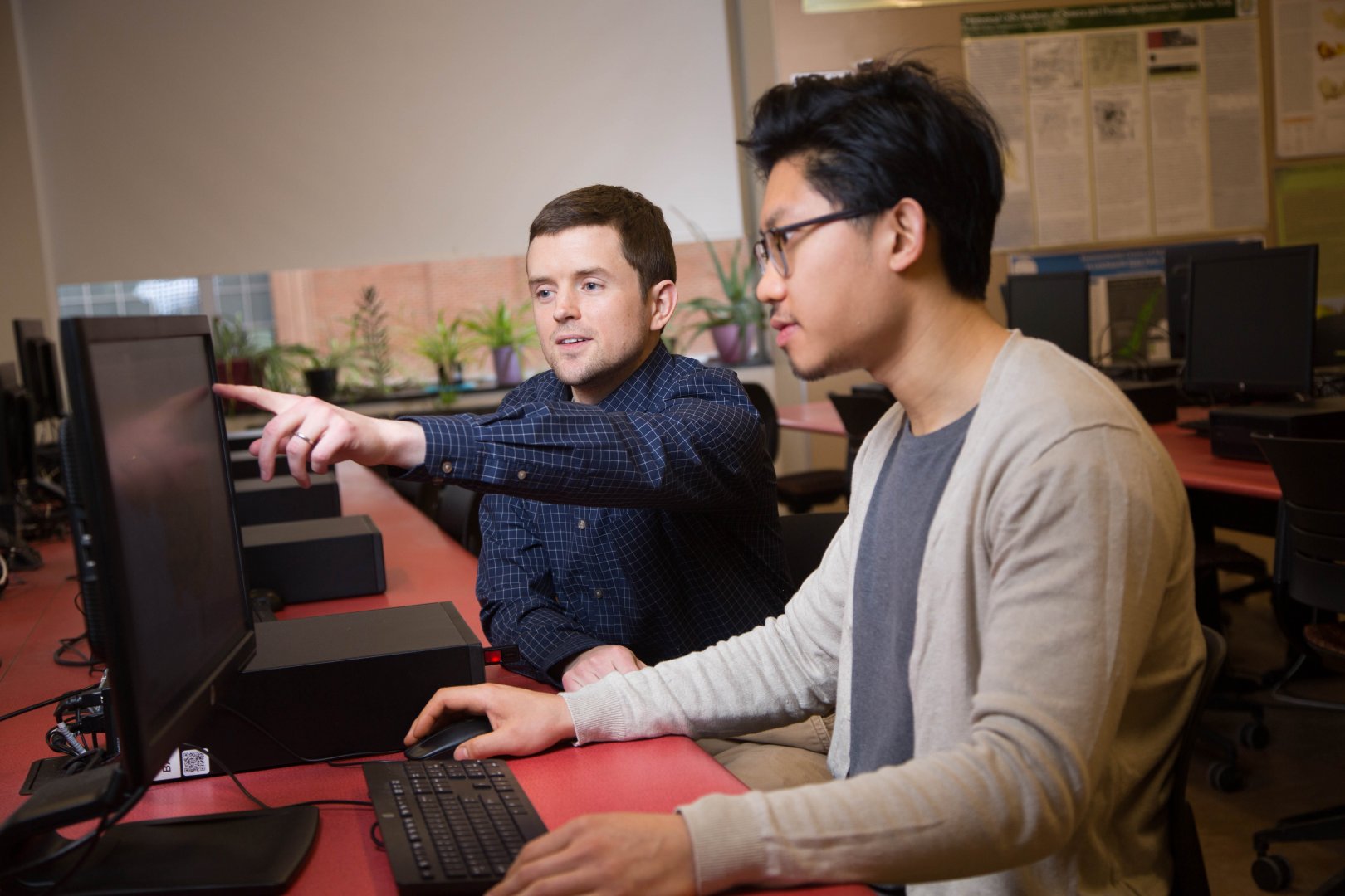 Geography Major, Jimmy Feng, working in GIS with Dr. Stephen Tulowiecki