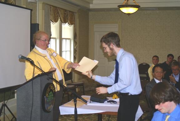 Professor Meg Stolee presents a scholarship award to William Koch