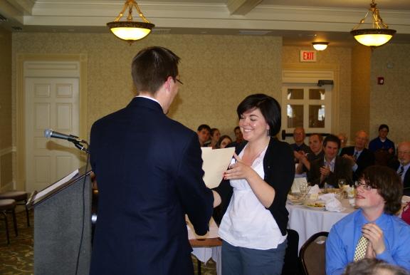 Professor Justin Behrend presents a scholarship award to Katie Smart