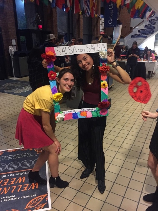 Salsa Con Salsa event, students posing with photobooth props