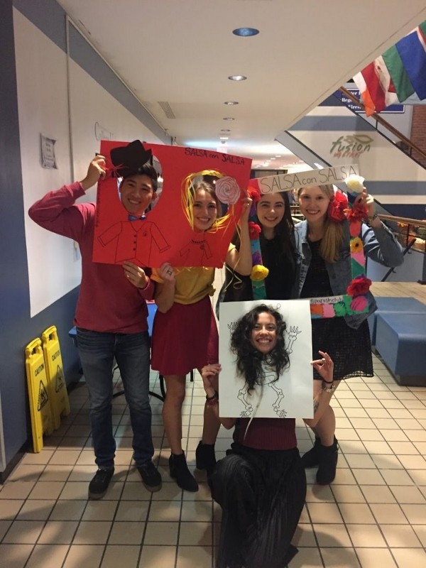 Salsa Con Salsa event, students posing with photobooth props