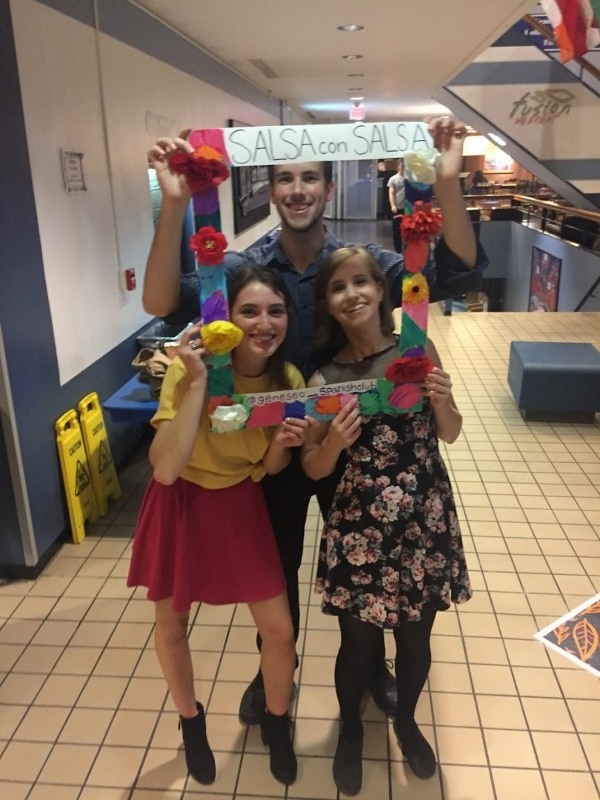 Salsa Con Salsa event, students posing with photobooth props