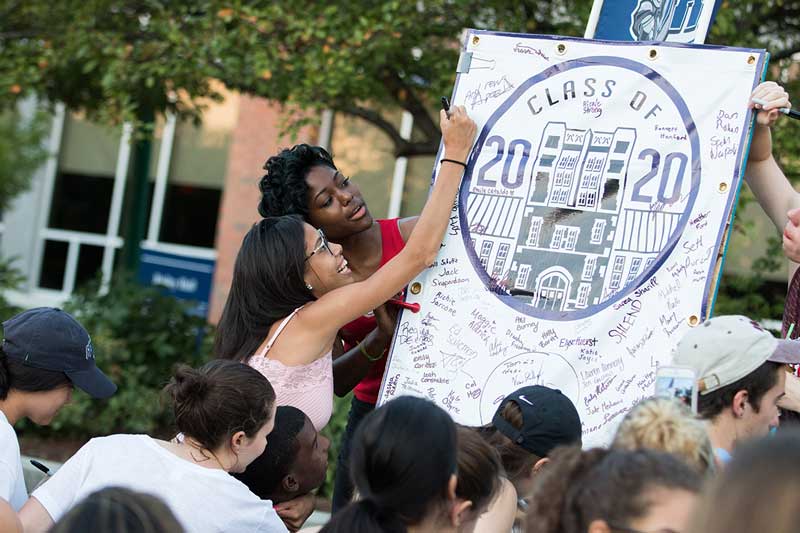 New student sign the Class of 2020 banner during First Knight festivities