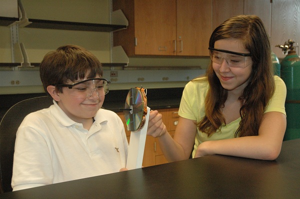 Two middle school students doing a simple physics project.