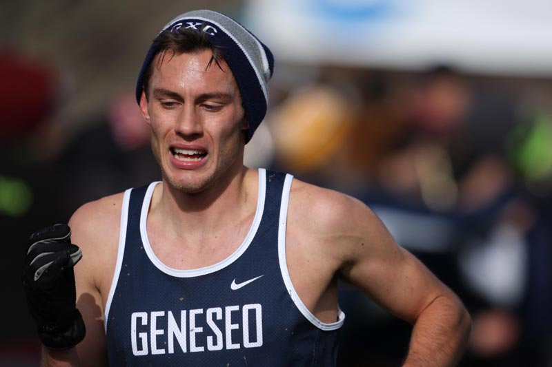 A SUNY Geneseo cross country runner completing a race.