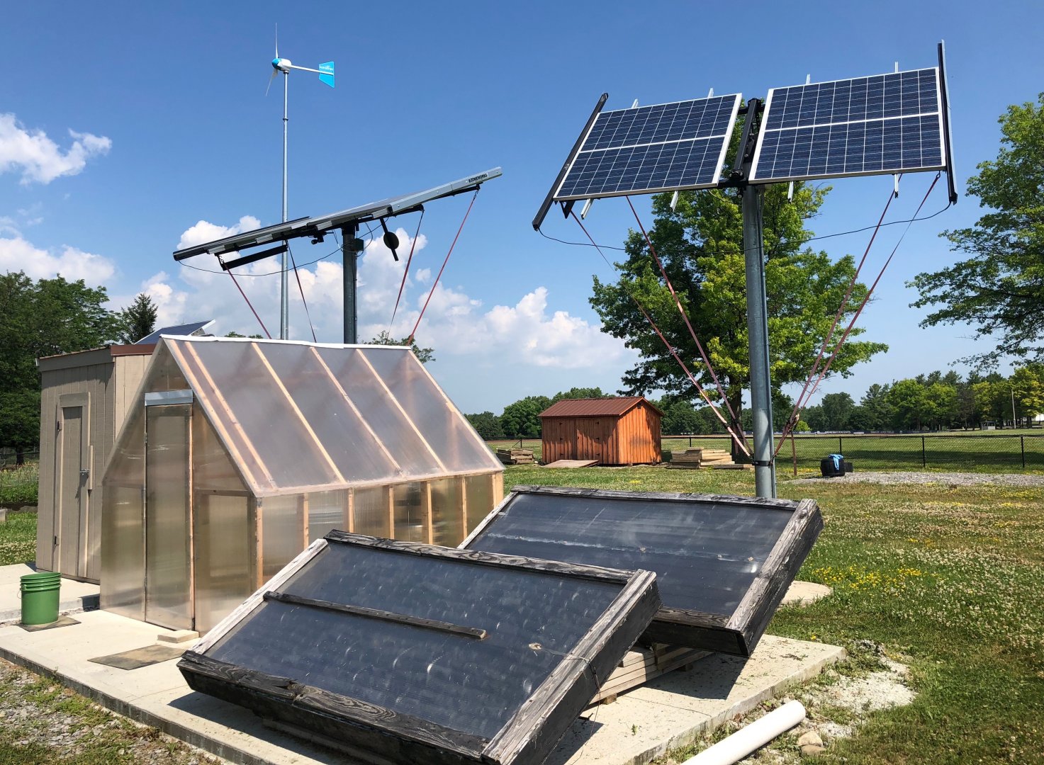 The renewable energy installations in the eGarden include solar collectors, two solar arrays, a wind turbine, and a greenhouse. 