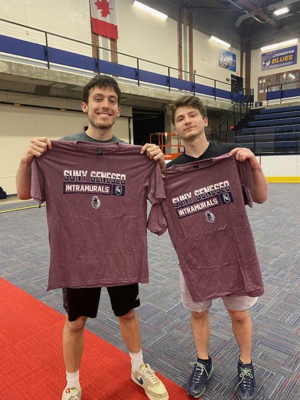 Two Kan Jam champions holding purple uniforms