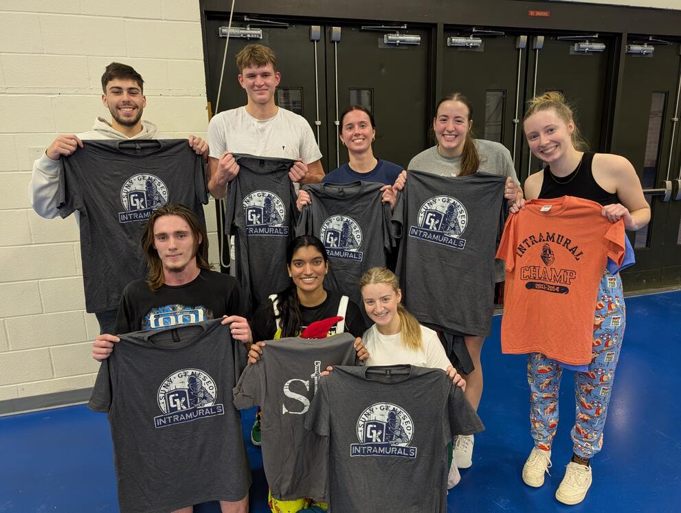 8 basketball champions holding gray intramural t-shirts.