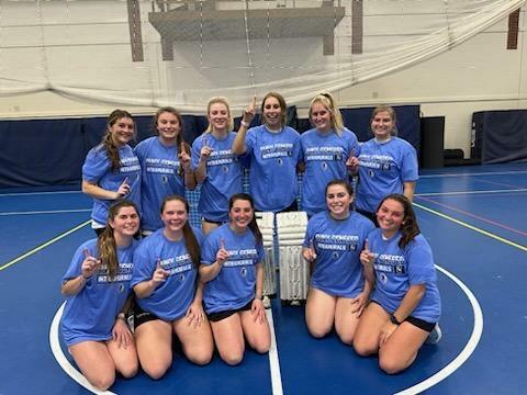 Group of floor hockey champions wearing blue intramural shirts.
