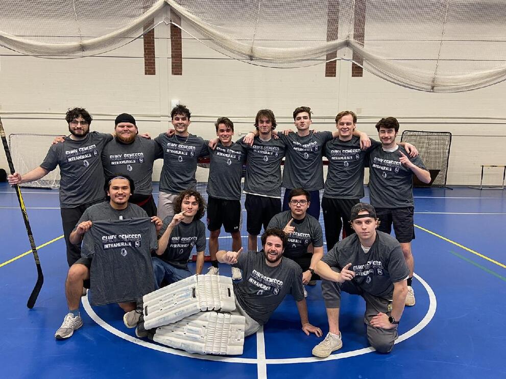 Group of floor hockey champions wearing black intramural shirts.