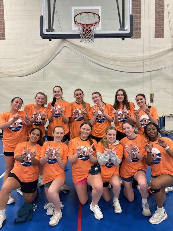 13 basketball champions wearing orange intramural t-shirts.