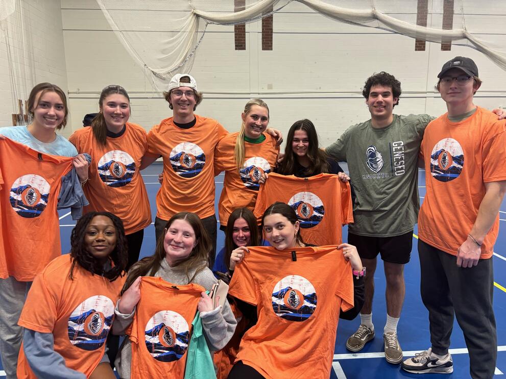 2 dodgeball champions wearing orange intramural t-shirts.