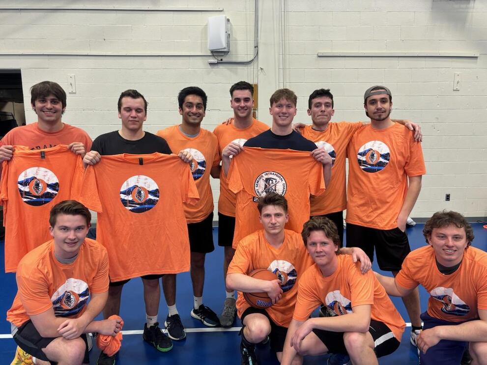 Group of basketball champions wearing orange intramural t-shirts.