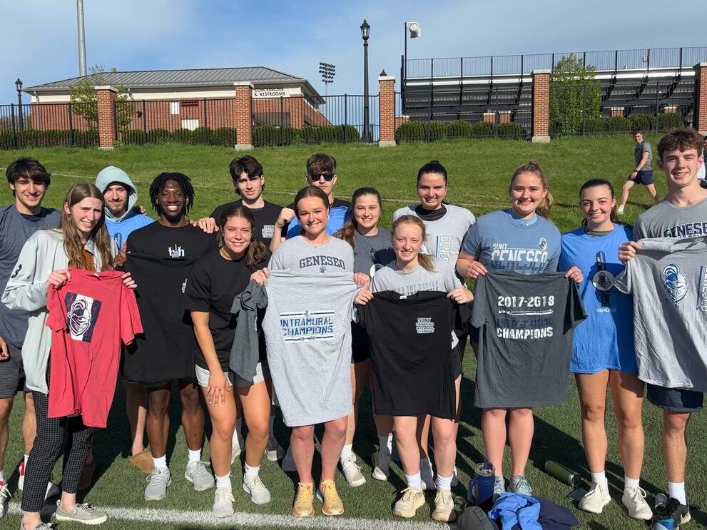 Group of kickball champions wearing gray and black intramural t-shirts.