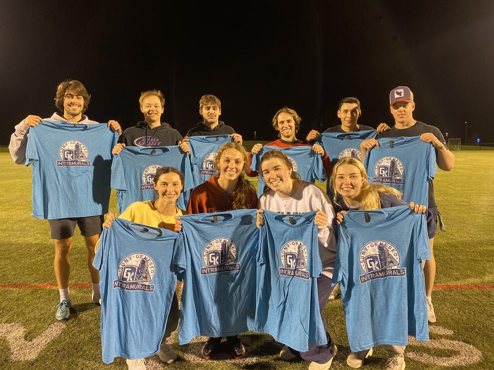 10 football champions holding blue intramural t-shirts.