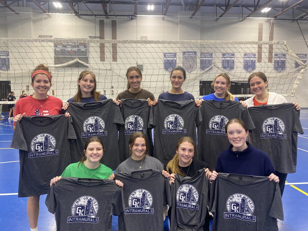 10 volleyball champions holding blue intramural t-shirts.