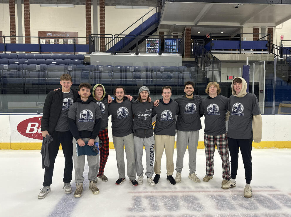9 broomball champions wearing gray intramural t-shirts.