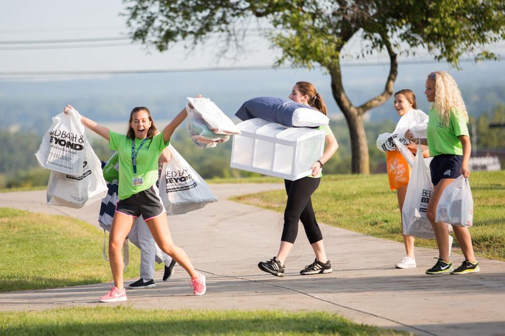 Students smiling after returning with apartments supplies on move in day
