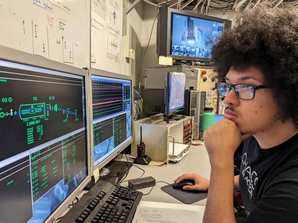 student at control console for accelerator