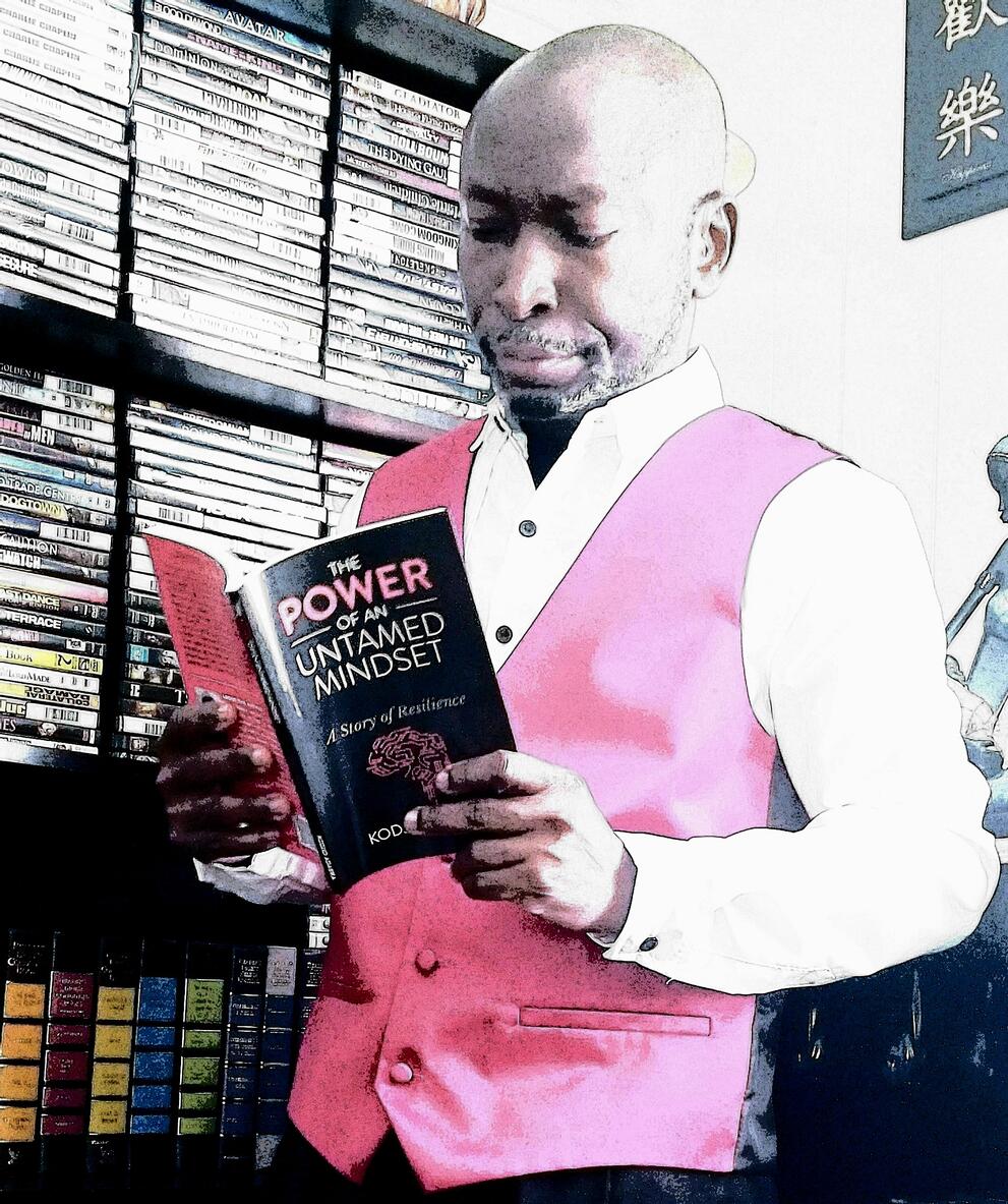 Dr. Adabra reading his book The Power Of An Untamed Mindset