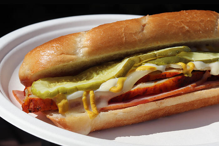 Toasted hoagie with ham, pork, swiss cheese, dill pickles, mayo, and yellow mustard