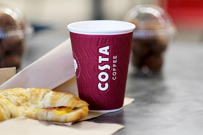 Costa Coffee beverage and a breakfast croissant sandwich.