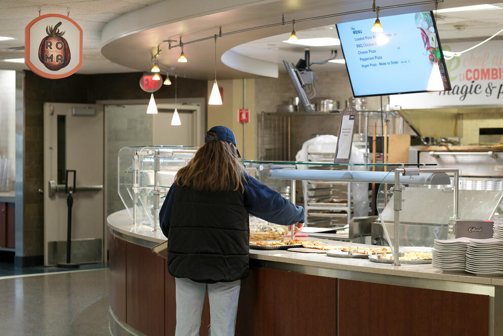 Student getting pizza at the Roma station in Letchworth Dining Complex.