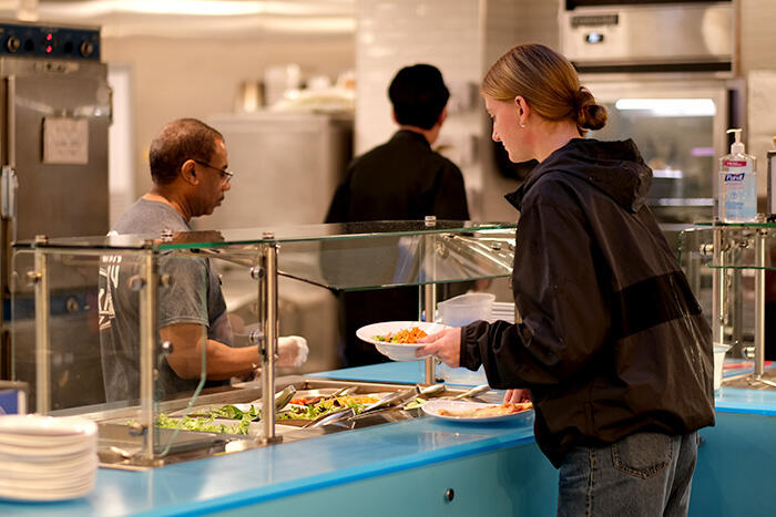 Student fills their plate at the salad bar in Red Jacket Dining Hall.