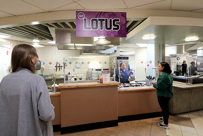 Two students approaching the Gluten-Friendly Lotus station at Mary Jemison Dining Complex.