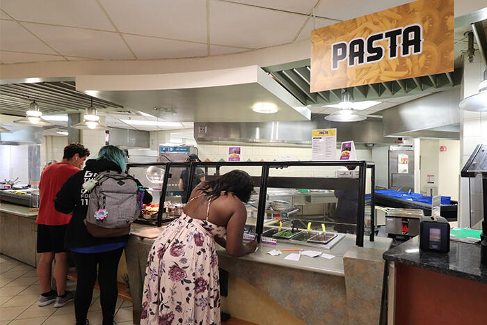 Students ordering custom dishes at the Pasta station in Mary Jemison Dining Complex.