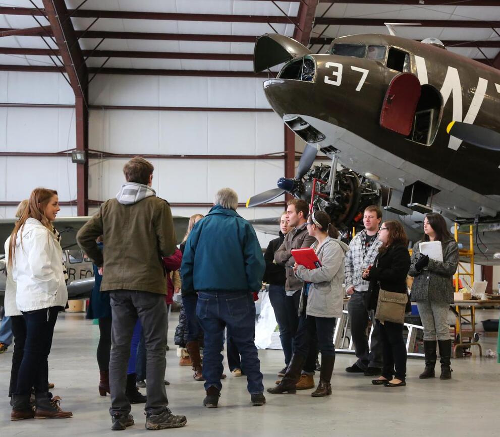 Group of people talking at the Plane Museum