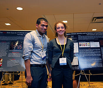 Two students presenting a poster