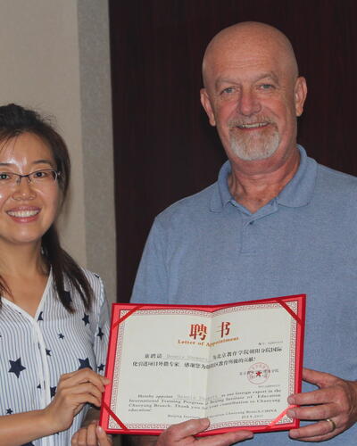  Dr. Showers receiving a certificate acknowledging him as a Foreign Expert in Interdisciplinary Teaching by The Changyang District of Beijing Schools