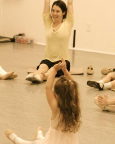 Jody DeLoria leading stretches in a dance class.