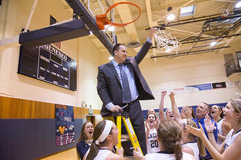 Women's basketball coach Scott Hemer at the basket