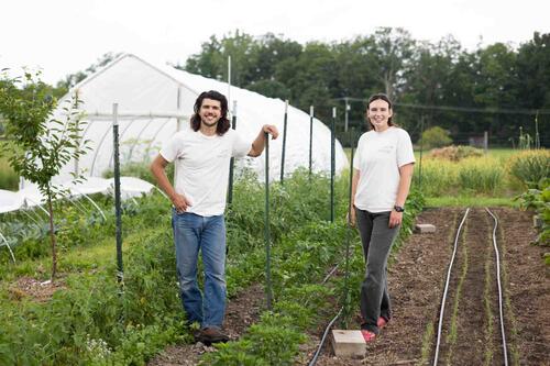 Sean Perry and Bari Zeiger standing in a field