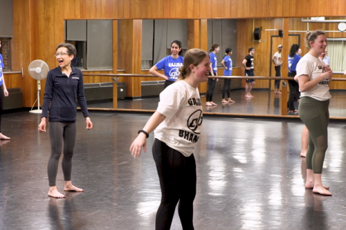 President Denise A. Battles practices with the Bhangra dance crew in a dance studio