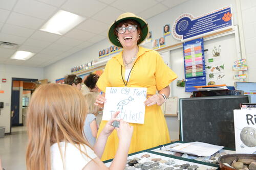 Sarah Hill Stone '12/MSEd '16 works with a student in a classroom.