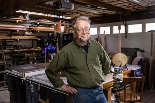 John "JD" Dennis ’79, co-owner of Hickory Street Banjo in Rochester. Dennis owns the company, based out of his home in Rochester’s South Wedge neighborhood, with his longtime friend David Frenzel. /Photo by Matt Burkhartt