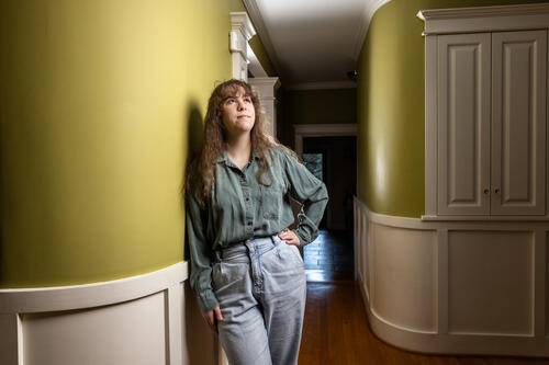 Jenna Huizinga '23 stands in a home with Thomas W. Boyde Jr.'s signature rounded walls.