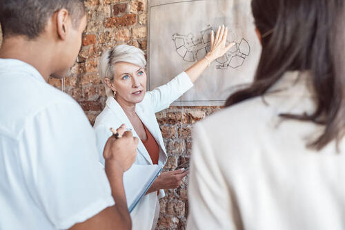 woman pointing at architectural drawing