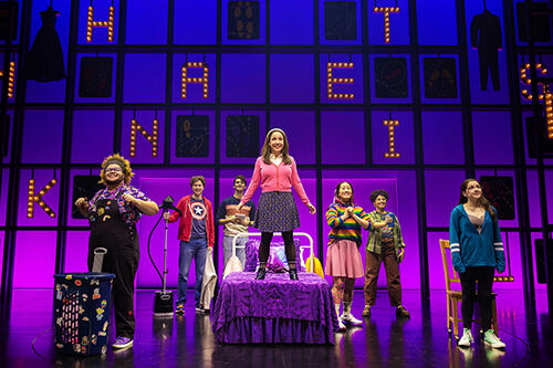 Photograph of Ashley Wool '09 singing in the broadway show, How to Dance in Ohio